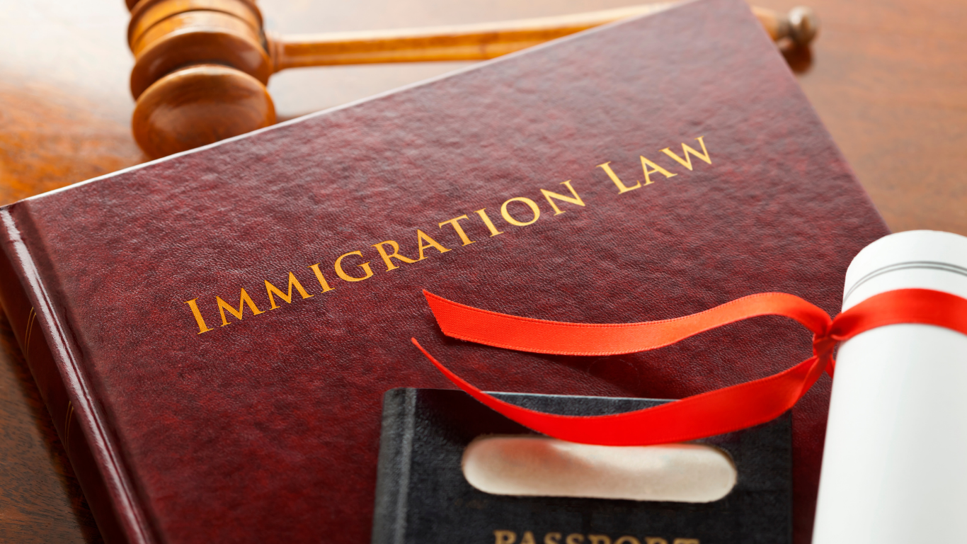 Immigration law book with a gavel, passport, and legal document on a desk
